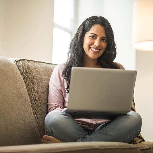 latin american hispanic woman using laptop at home
